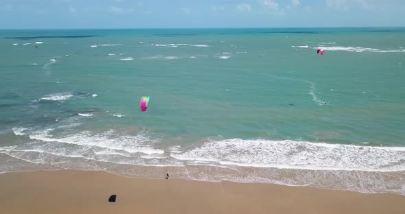 Aerial drone view of a woman walking after kiteboarding on a kite board