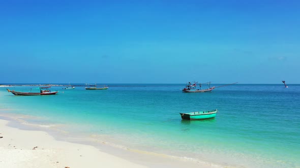 Paradise sandy beach, turquoise sea and fishing boats in calm lagoon. Koh Tao, Thailand