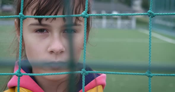 Pensive Girl on Sport Ground