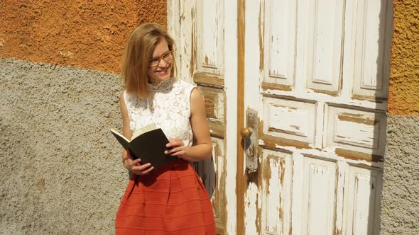 Female Model Holding a Book Going Through the Pages