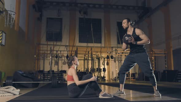 Young Woman Exercises with Trainer