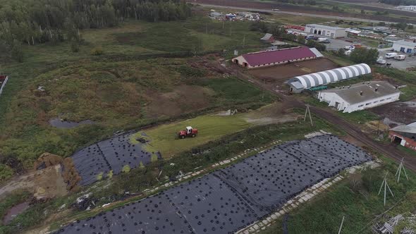 Aerial view of tractor dropping green silo. 03