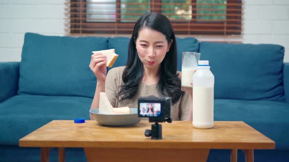 Asian women using camera streaming and recording vlog video about the benefit for broadcast online.