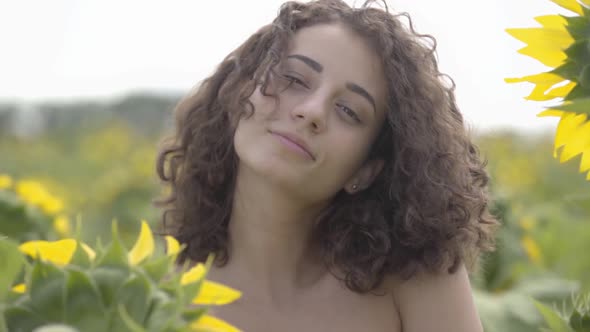 Portrait of Cute Fun Curly Playful Sensual Woman Looking at the Camera Smiling