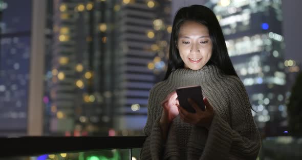 Woman use of smart phone at night