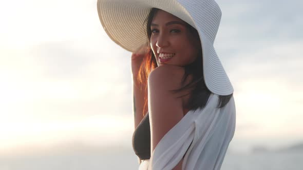 Woman In Sun Hat And Bikini Smiling To Camera