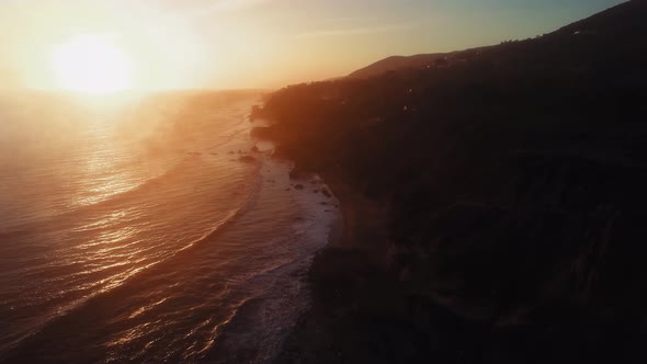 Drone footage of rippling ocean surface and the shore at El Matador Beach, Malibu, Califronia, USA