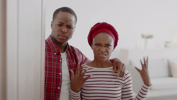Discontented African Couple Opening The Door Expressing Aggression At Home