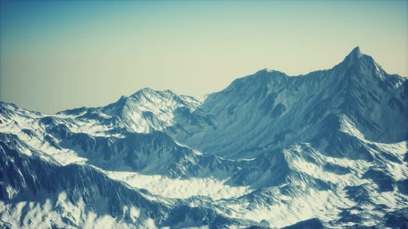Aerial View of the Alps Mountains in Snow alt