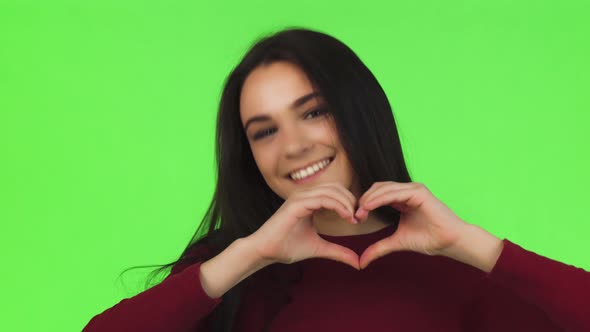 Happy Beautiful Woman Smiling Showing Heart Sign