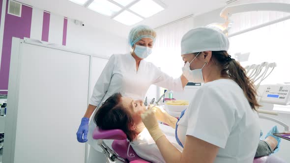 Dentists are Fixing Female Patient's Teeth