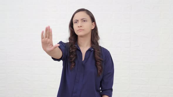 Indian girl showing STOP sign