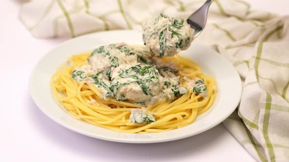 Portion of Delicious Meatballs with Spinach in a Creamy Sauce