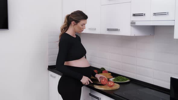 Woman Keeping Her Pregnancy Eating Plan and Making a Vegetable Salad