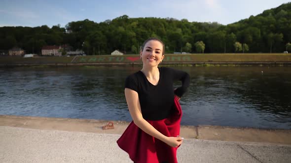 Attractive Caucasian dancer dancing in front of a Nemunas river