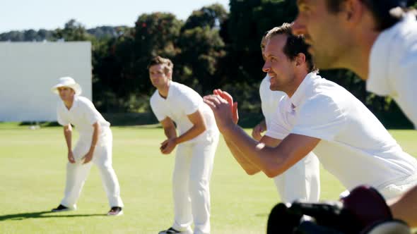 Cricket players doing catching practice