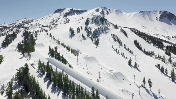 Cinematic Aerial of Sky Resort on Light Snowfall Winter Day Sports Background