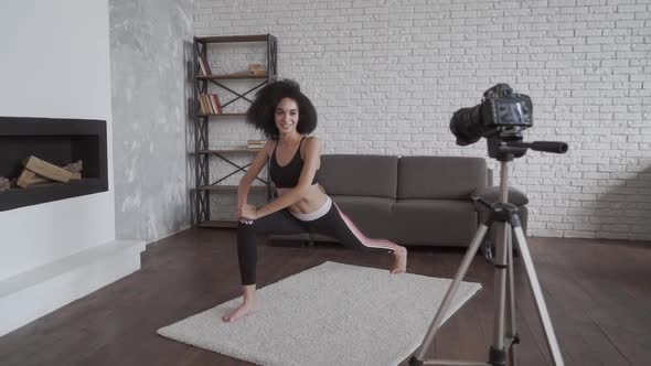 Young Woman Exercising at Home, Stretching. Vloging and Exercises in Front of the Camera. Good
