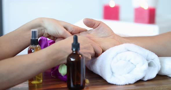 Masseuse Makes Massage of Hands to Client Closeup