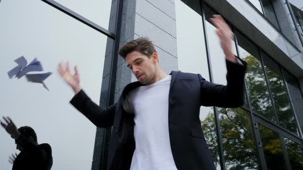 Angry furious male office worker throwing crumpled paper, having nervous breakdown at work