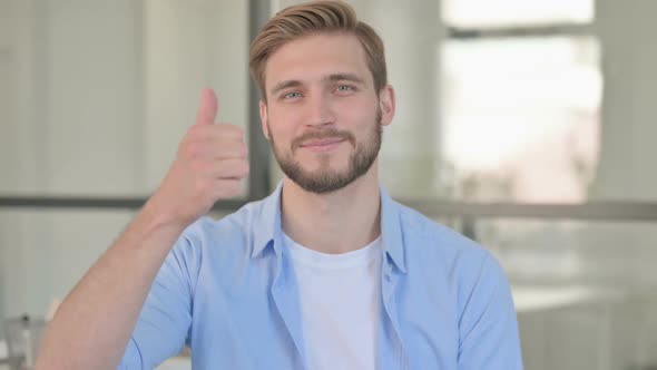 Portrait of Young Creative Man Showing Thumbs Up Sign