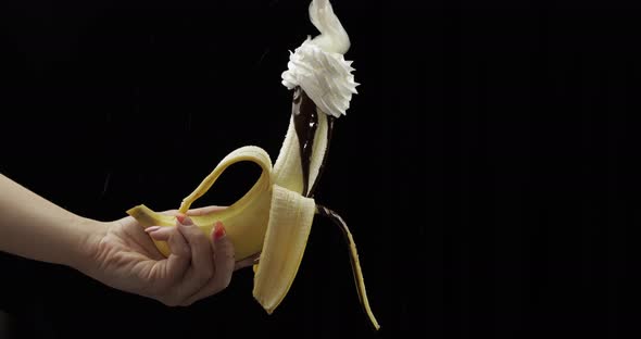 Holds Banana with Melted Chocolate. Squeeze Out Whipped Cream on Top of Fruit