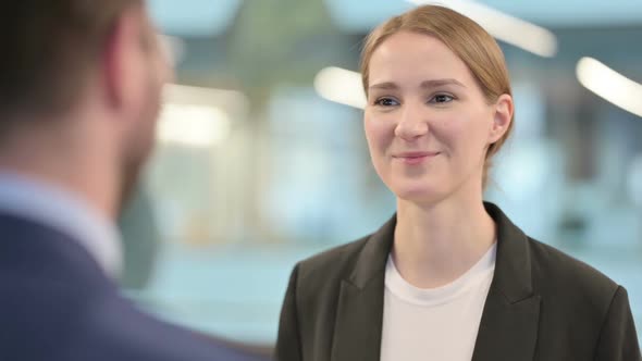 Businesswoman Talking with Businessman at Work