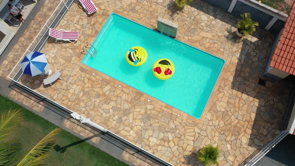 Float smile emoji emoticon icon buoy at swimming pool at countryside