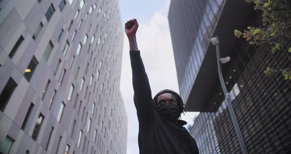 Confident Black African American Man Protests Against Discrimination Standing Looking at Camera