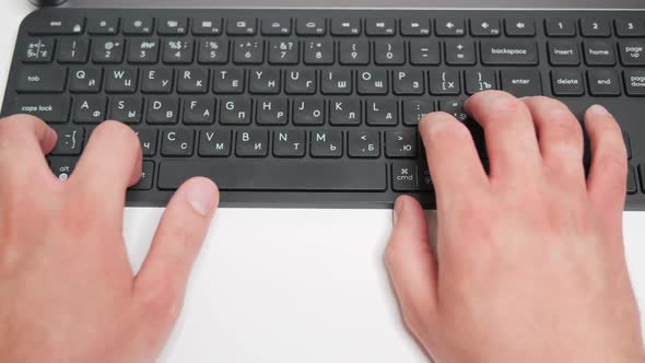 A Man Types on a Russianlanguage Keyboard