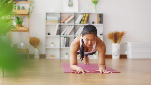 Asian woman practice yoga Plank pose to meditation at home