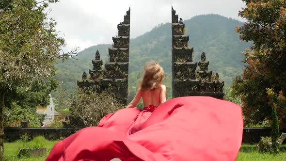 Woman Runs to Balinese Gates in Dress Slowmotion