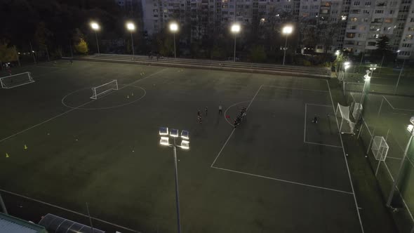 Soccer or Football Field in a Park at Night with Lights