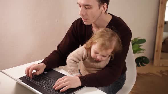 A Man Works at His Laptop at Home