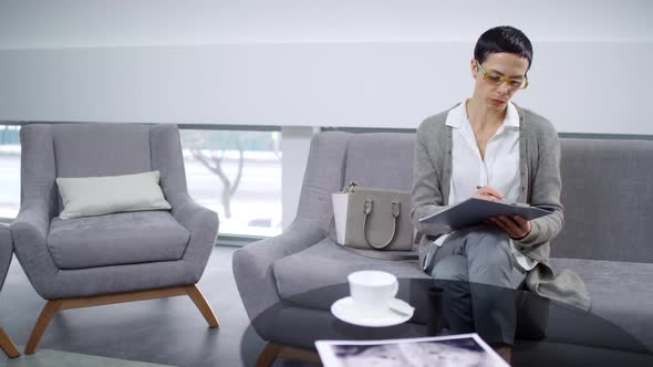 Mature Woman Filling Registration Form before Doctors Appointment