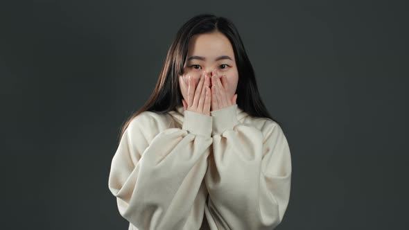 Young Frightened Asian Woman Shocked Isolated Over Grey Background.