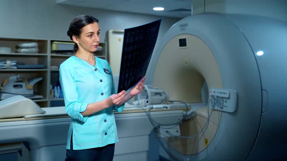 Female doctor examining x-ray photo