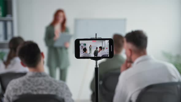 Remote Meeting Young Woman Conducts Training to Business Team Showing Presentation on Flipchart