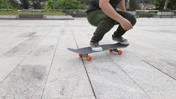 Asian woman skateboarder legs skateboarding outdoors