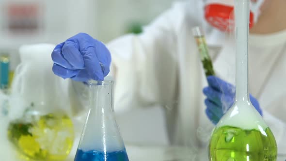 Woman Scientist Adding Agent Into Test Tube With Plant, Conducting Researches