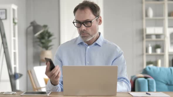 Old Businessman Talking on Phone