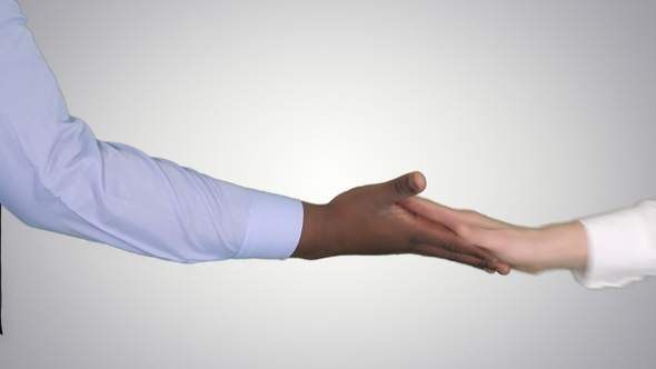 Black male and gradient female hands giving low five on