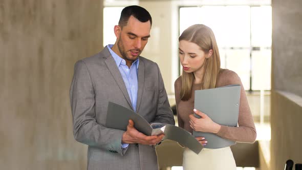 Businesswoman and Businessman Discussing Folder 1