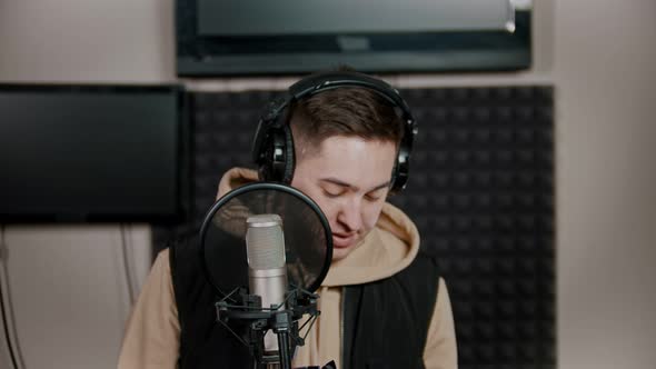 A Young Man Rapper Recording His Track in the Studio