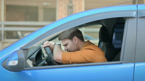 Hopeless Young Man Feeling Sad while Sitting in Car