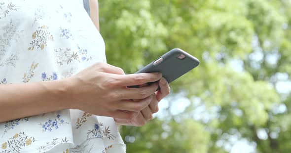 Woman using mobile phone over green background 