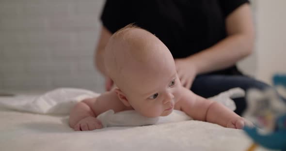 Close View of Little Baby and His Funny Behavior During Massage Process