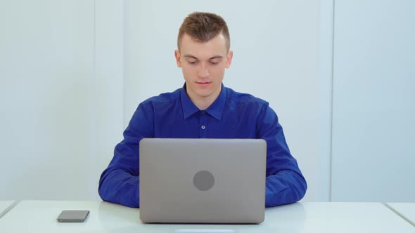 Office Businessman Works on a Laptop