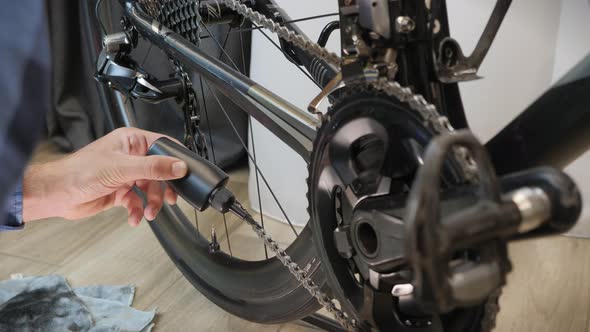 Mechanic lubricates bicycle chain