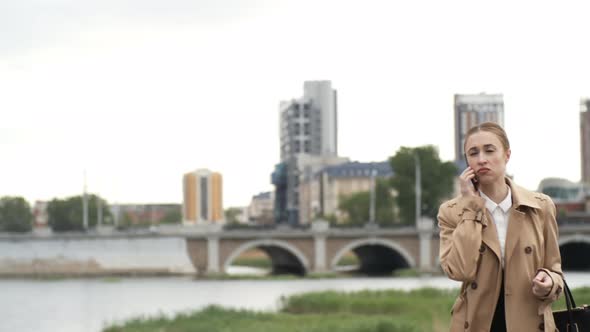 Businesswoman Walking and Talking on Phone